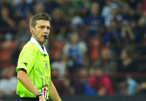 Italian referee Gianluca Rocchi looks on after showing a red card to Nigerian midfielder Joel Obi (unseen) during the Italian serie A football match Inter Milan vs Napoli, at San Siro stadium in Milan on October 1, 2011. Inter Milan coach Claudio Ranieri blasted referee Gianluca Rocchi after his team were beaten 3-0 at home by Napoli in a match they finished with 10 men. Inter had Joel Obi sent off in the first half for a second yellow card while Ranieri himself also saw red after raging at the referee at the break. Television replays showed Obi's first yellow was given for a good tackle while his second, which resulted in a penalty, was for a foul that happened outside the box. AFP PHOTO/ ALBERTO PIZZOLI (Photo credit should read ALBERTO PIZZOLI/AFP/Getty Images)