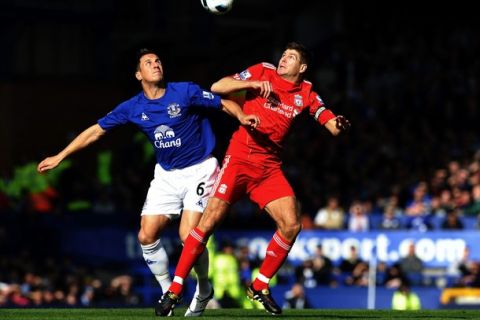 Liverpool's English midfielder Steven Gerrard (R) and Everton's English midfielder Phil Jagielka compete for the ball during their English Premier League football match at Goodison Park in Liverpool, north-west England, on October 17, 2010. AFP PHOTO/PAUL ELLIS -  FOR EDITORIAL USE ONLY Additional licence required for any commercial/promotional use or use on TV or internet (except identical online version of newspaper) of Premier League/Football League photos. Tel DataCo +44 207 2981656. Do not alter/modify photo. (Photo credit should read PAUL ELLIS/AFP/Getty Images)
