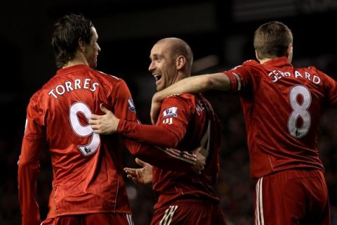 LIVERPOOL, ENGLAND - JANUARY 26:  Raul Meireles of Liverpool celebrates with team mates Fernando Torres and Steven Gerrard after John Pantsil of Fulham scored an own goal during the Barclays Premier League match between Liverpool and Fulham at Anfield on January 26, 2011 in Liverpool, England.  (Photo by Alex Livesey/Getty Images)