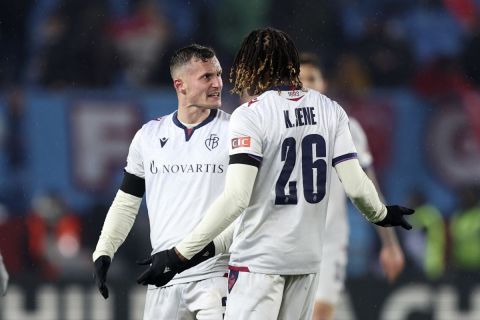 Basel's Taulant Xhaka, left, argues with Basel's Kaly Sene at the end of a Europa Conference League playoff first leg soccer match between Trabzonspor and Basel at the Senol Gunes stadium in Trabzon, Turkey, Thursday, Feb. 16, 2023. (AP Photo)