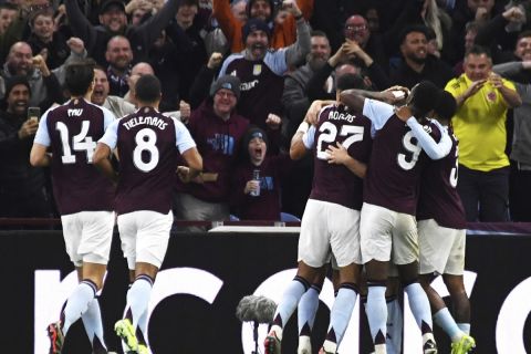 Aston Villa's John McGinn is congratulated by teammates after scoring the opening goal during the Champions League opening phase soccer match between Aston Villa and Bologna at the Villa Park in Birmingham, England, Tuesday, Oct. 22, 2024. (AP Photo/Rui Vieira)