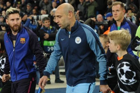 Barcelonas Lionel Messi, left, and Manchester Citys Pablo Zabaleta take to pitch during the Champions League group C soccer match between Manchester City and Barcelona at the Etihad stadium in Manchester, England, Tuesday, Nov. 1, 2016. (AP Photo/Rui Vieira)
