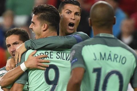 Portugal's Cristiano Ronaldo, background centre celebrates Andre Silva's goal with teammates, during the World Cup Group B first round soccer match between Hungary and Portugal, at the Groupama Arena, in Budapest, Hungary, Sunday, Sept. 3, 2017. (Tamas Kovacs//MTI via AP)