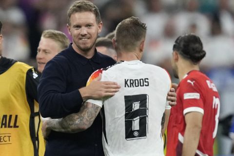 Germany's head coach Julian Nagelsmann hugs with Germany's Toni Kroos after a Group A match between Switzerland and Germany at the Euro 2024 soccer tournament in Frankfurt, Germany, Sunday, June 23, 2024. (AP Photo/Darko Vojinovic)