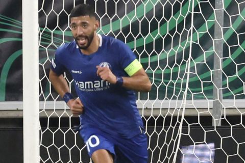 Gent's Tarik Tissoudali, left, celebrates after scoring his side's opening goal during the Europa Conference League play off second leg soccer match between Gent and Maccabi Haifa at the KAA Gent Arena in Ghent, Belgium, Wednesday, Feb. 21, 2024. (AP Photo/Geert Vanden Wijngaert)