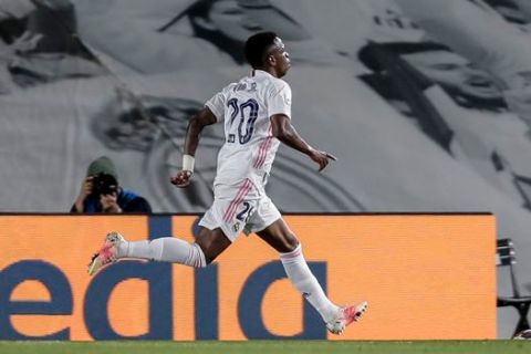 Real Madrid's Vinicius Junior celebrates after scoring the opening goal during the Champions League quarterfinal first leg, soccer match between Real Madrid and Liverpool at the Alfredo di Stefano stadium in Madrid, Spain, Tuesday, April 6, 2021. (AP Photo/Manu Fernandez)