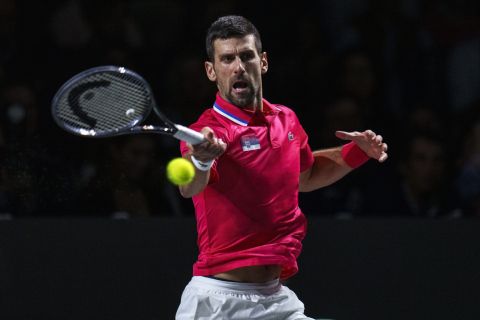 Novak Djokovic of Serbia returns the ball against Jannik Sinner of Italy during a Davis Cup semi-final tennis match between Italy and Serbia in Malaga, Spain, Saturday, Nov. 25, 2023. (AP Photo/Manu Fernandez)