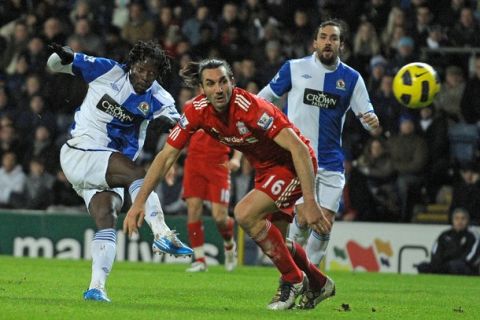 Blackburn Rovers' Zimbabwean striker Benjani Mwaruwari (L) scores Blackburn's second goal past Liverpool's Greek defender Sotirios Kyrgiakos (2nd L) during the English Premier League football match between Blackburn Rovers and Liverpool at Ewood Park in Blackburn, north-west England, on January 5, 2011. AFP PHOTO/ANDREW YATESFOR EDITORIAL USE ONLY Additional licence required for any commercial/promotional use or use on TV or internet (except identical online version of newspaper) of Premier League/Football League photos. Tel DataCo +44 207 2981656. Do not alter/modify photo. (Photo credit should read ANDREW YATES/AFP/Getty Images)