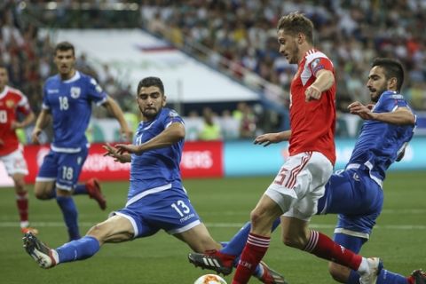 Russia's Aleksei Miranchuk, 2nd right, fights for the ball with Cyprus' Ioannis Kousoulos, left, and Kostas Laifis, right, during the Euro 2020 group I qualifying soccer match between Russia and Cyprus at the Nizhniy Novgorod Stadium in Nizhniy Novgorod, Russia, Tuesday, June 11, 2019. (AP Photo)