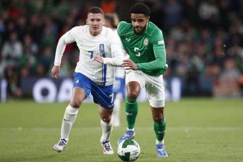 Republic of Ireland's Andrew Omobamidele, right, and Greece's Christos Tzolis in action during the UEFA Nations League soccer match between Republic of Ireland and Greece at the Aviva Stadium in Dublin, Ireland, Tuesday, Sept. 10, 2024. (AP Photo/Peter Morrison)