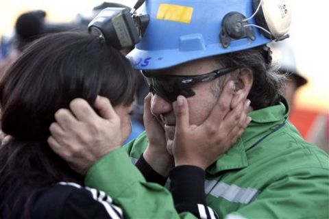 In this photo released by the Chilean government, miner Franklin Lobo, right, embraces his daughter Carolina after he was rescued from the collapsed San Jose gold and copper mine where he had been trapped with 32 other miners for over two months near Copiapo, Chile, Wednesday Oct. 13, 2010. (AP Photo/Chilean government, Gabriel Ortega)