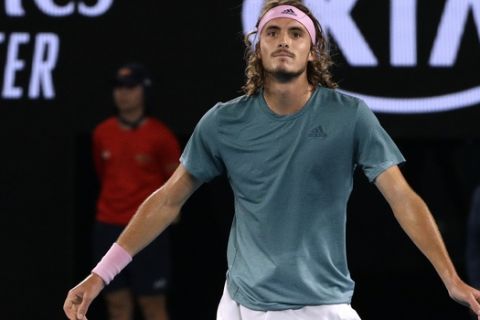 Greece's Stefanos Tsitsipas celebrates after defeating Switzerland's Roger Federer in their fourth round match at the Australian Open tennis championships in Melbourne, Australia, Sunday, Jan. 20, 2019. (AP Photo/Mark Schiefelbein)