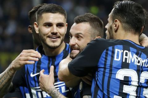 Inter Milan's Marcelo Brozovic celebrates with teammates Mauro Icardi, left, and Danilo D'Ambrosio after scoring his side's third goal during an Italian Serie A soccer match between Inter Milan and Cagliari, at the San Siro stadium in Milan, Italy, Tuesday, April 17, 2018. (AP Photo/Antonio Calanni)