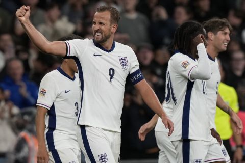 England's Harry Kane, left, celebrates after scoring his side's second goal during the Group F UEFA Nations League soccer match between England and Finland at Wembley Stadium in London, Tuesday, Sept. 10, 2024. (AP Photo/Frank Augstein)