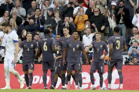 England's Cole Palmer, 2nd right, celebrates with his teammate after scoring the opening goal from the penalty spot during an international friendly soccer match between England and Bosnia and Herzegovina at St. James Park in Newcastle, England, Monday, June 3, 2024. (AP Photo/Scott Heppell)