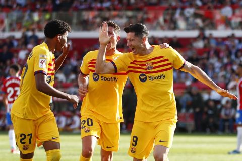 Barcelona's Robert Lewandowski, right, celebrates after scoring his side's second goal during the Spanish La Liga soccer match between Girona and Barcelona, at the Montilivi stadium in Girona, Spain, Saturday, May 4, 2024. (AP Photo/Joan Monfort)