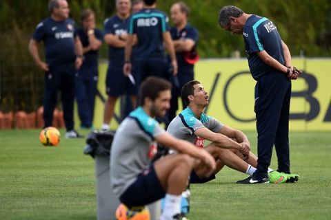 Portugal's coach Fernando Santos (R) talks to forward Cristiano Ronaldo during a training session at Praia del Rey, near Obidos on October 6, 2014. Portugal started a training camp in preparation for their upcoming friendly match against France and qualifying match against Denmark. AFP PHOTO/ FRANCISCO LEONG        (Photo credit should read FRANCISCO LEONG/AFP/Getty Images)