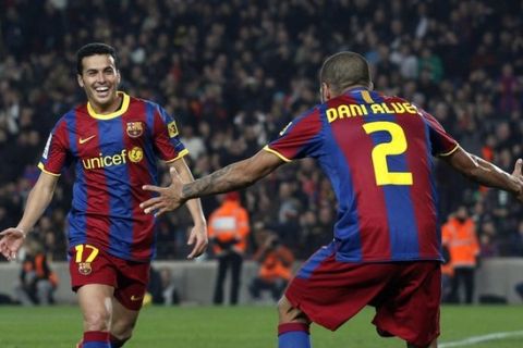 Barcelona's Dani Alves (R) and Pedro Rodriguez celebrate their second goal against Levante during their Spanish First Division Soccer League match at Nou Camp Stadium in Barcelona January 2, 2011. REUTERS/Albert Gea (SPAIN - Tags: SPORT SOCCER)