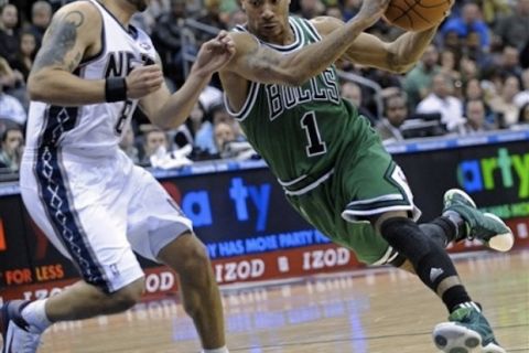 Chicago Bulls' Derrick Rose, right, drives to the basket against New Jersey Nets' Deron Williams during the fourth quarter of an NBA basketball game Thursday, March 17, 2011 in Newark, N.J. The Bulls won 84-73. (AP Photo/Bill Kostroun)