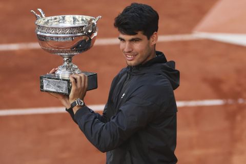 Winner Spain's Carlos Alcaraz celebrates with the trophy as he won the men's final match of the French Open tennis tournament against Germany's Alexander Zverev at the Roland Garros stadium in Paris, Sunday, June 9, 2024. (AP Photo/Aurelien Morissard)