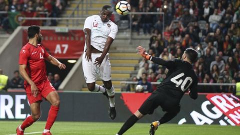 Portugal's William Carvalho, center, heads the ball to score a goal that was disallowed during a friendly soccer match between Portugal and Tunisia in Braga, Portugal, Monday, May 28, 2018. (AP Photo/Luis Vieira)