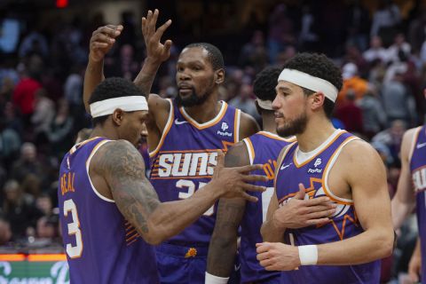 Phoenix Suns' Bradley Beal (3), left, Kevin Durant, center and Devin Booker, left, celebrate after an NBA basketball game against the Cleveland Cavaliers in Cleveland, Monday, March 11, 2024. (AP Photo/Phil Long)