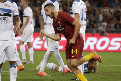 Roma's Kostas Manolas, center, celebrates after scoring his side's third goal during a Serie A soccer match between Roma and Atalanta, in Rome's Olympic stadium, Monday, Aug. 27, 2018. (AP Photo/Andrew Medichini)