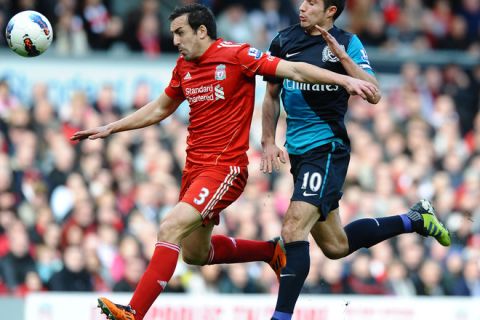 Liverpool's Spanish defender Jose Enrique (L) vies with Arsenal's Dutch striker Robin van Persie (R) during the English Premier League football match between Liverpool and Arsenal at Anfield in Liverpool, north-west England on March 3, 2012. AFP PHOTO/PAUL ELLIS

RESTRICTED TO EDITORIAL USE. No use with unauthorized audio, video, data, fixture lists, club/league logos or live services. Online in-match use limited to 45 images, no video emulation. No use in betting, games or single club/league/player publications. (Photo credit should read PAUL ELLIS/AFP/Getty Images)