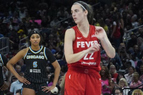 Chicago Sky forward Angel Reese, left, watches Indiana Fever guard Caitlin Clark take a free throw during the second half of a WNBA basketball game Friday, Aug. 30, 2024, in Chicago. (AP Photo/Erin Hooley)