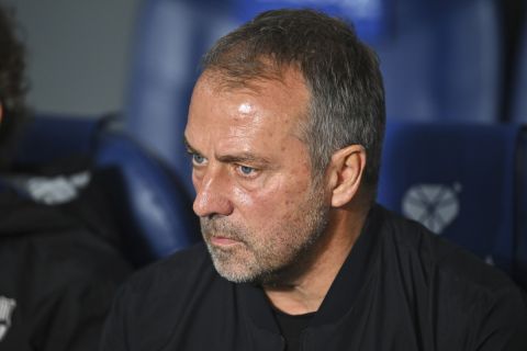 Barcelona's head coach Hansi Flick waits for the start of the Spanish La Liga soccer match between Real Sociedad and Barcelona at the Anoeta stadium, in San Sebastian, Spain, Sunday, Nov. 10, 2024. (AP Photo/Miguel Oses)