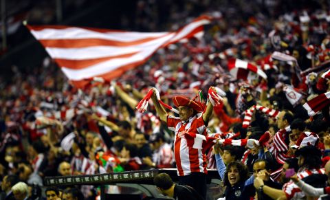 Athletic Bilbao's supporters celebrate as their team won 6-2 against Manchester United's, during their Europa League second leg, round of 16 soccer match at the  San Mames stadium in Bilbao, northern Spain, Thursday, March 15, 2012. (AP Photo/Juan Manuel Serrano Arce)