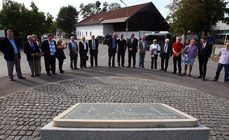 MUNICH, GERMANY - SEPTEMBER 27:  Manchester City representatives at the memorial stone in memory of the victims of the 1958 Munich Air Disaster at the old Munich-Riem airport at the Manchesterplatz on September 27, 2011 in Munich, Germany.  Manchester City representatives laid a wreath at a ceremony in memory of the victims of the 1958 Munich Air Disaster which claimed the lives of 23 people, including eight Manchester United players.  (Photo by Alexander Hassenstein/Bongarts/Getty Images)