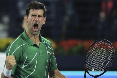 Serbia's Novak Djokovic celebrates after he beats Stefanos Tsitsipas of Greece in the final match of the Dubai Duty Free Tennis Championship in Dubai, United Arab Emirates, Saturday, Feb. 29, 2020. (AP Photo/Kamran Jebreili)