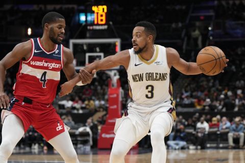 New Orleans Pelicans guard CJ McCollum (3) dribbles the ball down the court as Washington Wizards guard Jared Butler (4) defends during the first half of an NBA basketball game Sunday, Jan. 5, 2025, in Washington. (AP Photo/Jess Rapfogel)