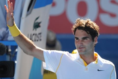 Roger Federer waves after defeating Xavier Malisse of Belgium during their round three men's singles match on the fifth day of the Australian Open tennis tournament in Melbourne on January 21, 2011.  Defending champion and second seed Federer cruised into the fourth round with a 6-3, 6-3, 6-1 win over Malisse whilst also breaking Stefan Edberg's record for the most Open Era wins at the Australian Open with 57.  IMAGE STRICTLY RESTRICTED TO EDITORIAL USE  STRICTLY NO COMMERCIAL USE   AFP PHOTO / WILLIAM WEST (Photo credit should read WILLIAM WEST/AFP/Getty Images)