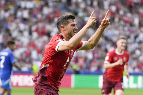 Switzerland's Remo Freuler celebrates after scoring during a round of sixteen match between Switzerland and Italy at the Euro 2024 soccer tournament in Berlin, Germany, Saturday, June 29, 2024. (AP Photo/Matthias Schrader)