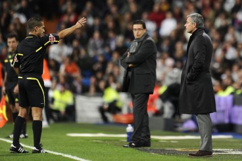 Real Madrid's Portuguese coach Jose Mourinho (R) is sent of by referee during the Spanish King's Cup (Copa del Rey) football match Real Madrid against Murcia on November 10, 2010 at the Santiago Bernabeu stadium in Madrid.    AFP PHOTO/ PIERRE-PHILIPPE MARCOU (Photo credit should read PIERRE-PHILIPPE MARCOU/AFP/Getty Images)