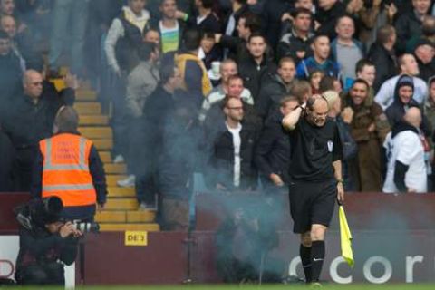 BIRMINGHAM, ENGLAND - OCTOBER 20: A  Linesman is hit by a flare during the Barclays Premier League match between Aston Villa and Tottenham Hotspur at Villa Park on October 20, 2013 in Birmingham, England.  (Photo by Neville Williams/Aston Villa FC via Getty Images)