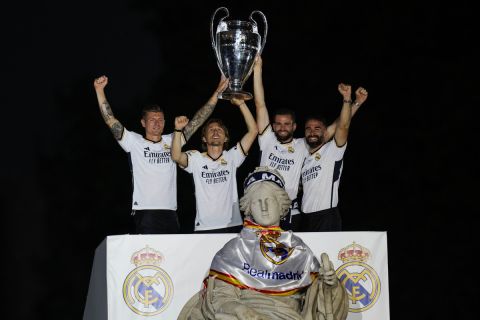 From left to right: Real Madrid players Toni Kroos, Luka Modric, Nacho and Dani Carvajal hold the Champions League trophy at the Cibeles square during a trophy parade in front of the City Hall in Madrid, Spain, Sunday, June 2, 2024. Real Madrid won against Borussia Dortmund 2-0. (AP Photo/Bernat Armangue)