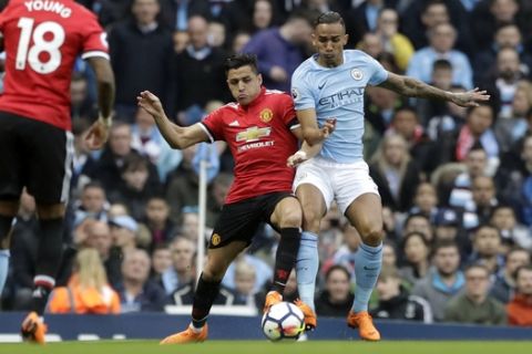 Manchester United's Alexis Sanchez fights for the ball with Manchester City's Danilo, right, during the English Premier League soccer match between Manchester City and Manchester United at the Etihad Stadium in Manchester, England, Saturday April 7, 2018. (AP Photo/Matt Dunham)