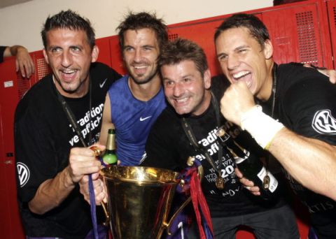 FC Basel's (FCB) Franco Costanzo (2nd L) holds the trophy with his team-mates after winning the Swiss Championships against FC Luzern in their Swiss Super League soccer match in Basel May 25, 2011. REUTERS/Romina Amato (SWITZERLAND - Tags: SPORT SOCCER)