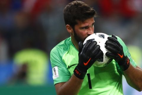 Brazil goalkeeper Alisson kisses the ball after makes a save during the group E match between Serbia and Brazil, at the 2018 soccer World Cup in the Spartak Stadium in Moscow, Russia, Wednesday, June 27, 2018. (AP Photo/Matthias Schrader)