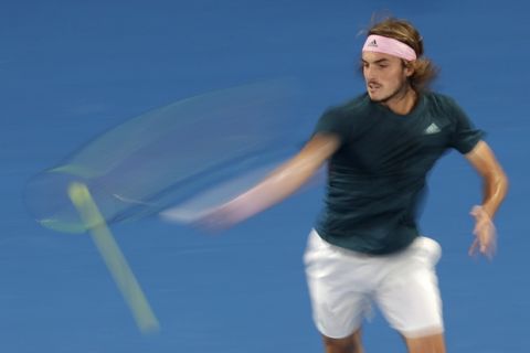 Greece's Stefanos Tsitsipas makes a forehand return to Spain's Rafael Nadal during their semifinal at the Australian Open tennis championships in Melbourne, Australia, Thursday, Jan. 24, 2019. (AP Photo/Kin Cheung)