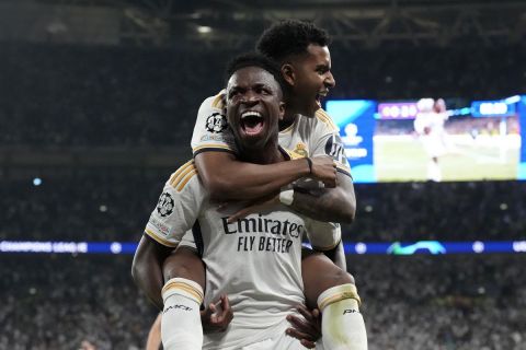 Real Madrid's Vinicius Junior celebrates with Rodrygo after scoring his side's second goal during the Champions League final soccer match between Borussia Dortmund and Real Madrid at Wembley stadium in London, Sunday, June 2, 2024. (AP Photo/Frank Augstein)