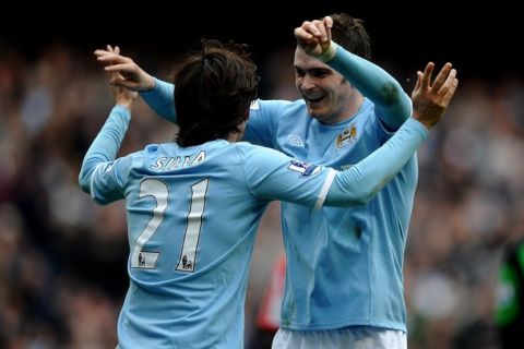 MANCHESTER, ENGLAND - APRIL 03:  David Silva of Manchester City celebrates scoring his team's third goal with team mate Adam Johnson (R) during the Barclays Premier League match between Manchester City and Sunderland at the City of Manchester Stadium on April 3, 2011 in Manchester, England.  (Photo by Laurence Griffiths/Getty Images)