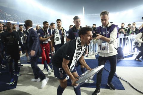 Paris Saint-Germain's Brazilian defender Marquinhos celebrates the French Ligue 1 title during a ceremony following the French L1 football match between Paris Saint-Germain (PSG) and Toulouse, Sunday, May 12, 2024 at the Parc des Princes stadium in Paris. (Franck Fife, Pool via AP)