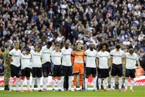 Tottenham Hotspur players observe a moments silence in memory of the Hillsborough stadium disaster where 96 Liverpool fans died April 15, 1989, before the start of the English FA Cup semifinal soccer match against Chelsea at Wembley Stadium in London, Sunday, April 15, 2012. (AP Photo/Tom Hevezi)