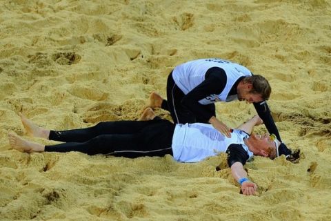 LONDON, ENGLAND - AUGUST 07: Julius Brink and Jonas Reckermann of Germany celebrate match point during the Men's Beach Volleyball Semi Final match between Germany and the Netherlands at Horse Guards Parade on August 7, 2012 in London, England.  (Photo by Michael Regan/Getty Images)