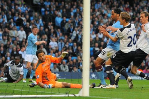 Tottenham Hotspur's English forward Peter Crouch (R) scores an own goal during the English Premier League football match between Manchester City and Tottenham Hotspur at The City of Manchester stadium, Manchester, north-west England on May 10, 2011.    AFP PHOTO/ ANDREW YATES
FOR  EDITORIAL USE Additional licence required for any commercial/promotional use or use on TV or internet (except identical online version of newspaper) of Premier League/Football League photos. Tel DataCo +44 207 2981656. Do not alter/modify photo (Photo credit should read ANDREW YATES/AFP/Getty Images)