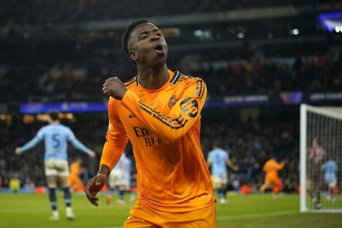 Real Madrid's Vinicius Junior celebrates after his teammate Real Madrid's Brahim Diaz scored their side second goal during the Champions League playoff first leg soccer match between Manchester City and Real Madrid at the Etihad Stadium in Manchester, England, Tuesday, Feb. 11, 2025. (AP Photo/Dave Thompson)